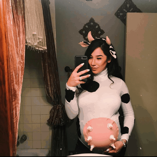 shows a pregnant woman dressed as a cow