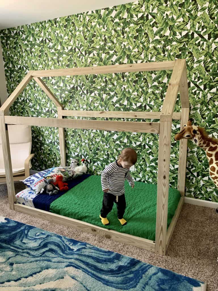 child on montessori house bed frame