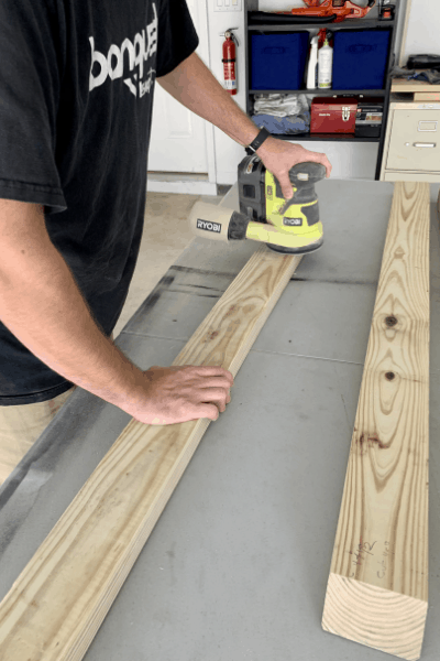 sanding the wood for the bed