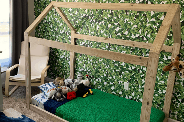 shows a boy laying in a house bed floor bed