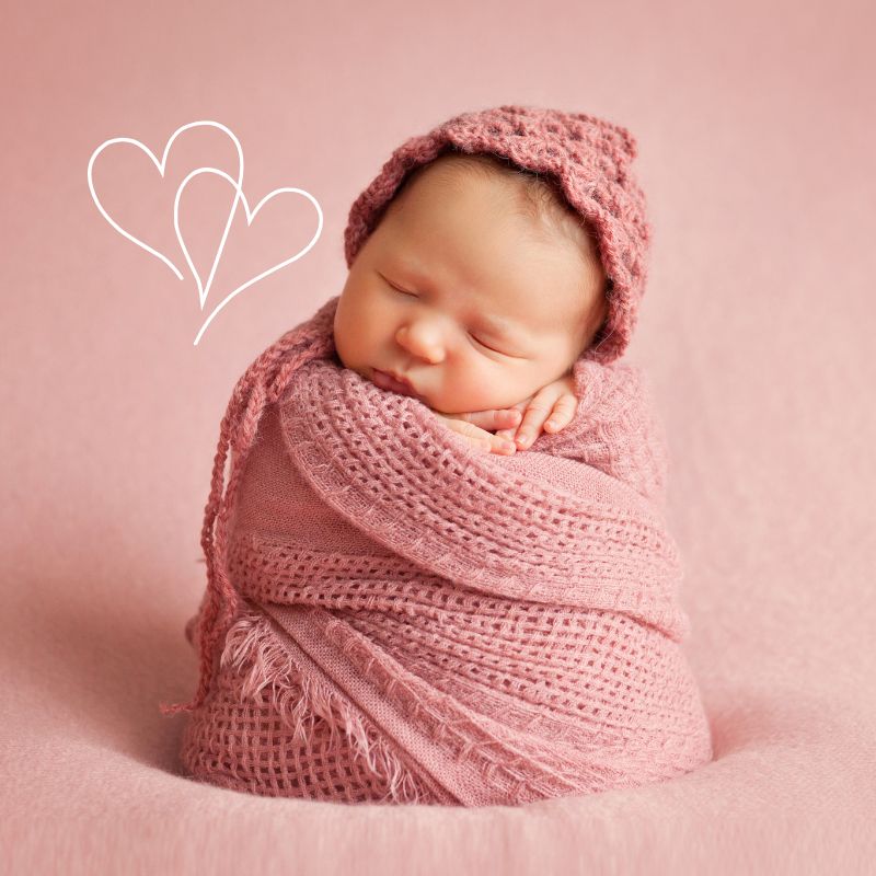 image shows a baby wrapped in pink