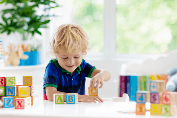 boy stacking blocks