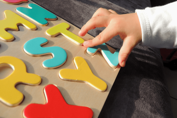 young child with abc board