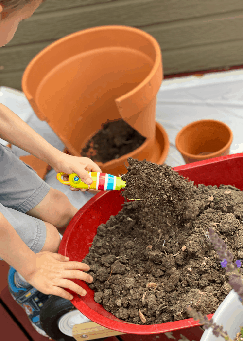 child scooping dirt