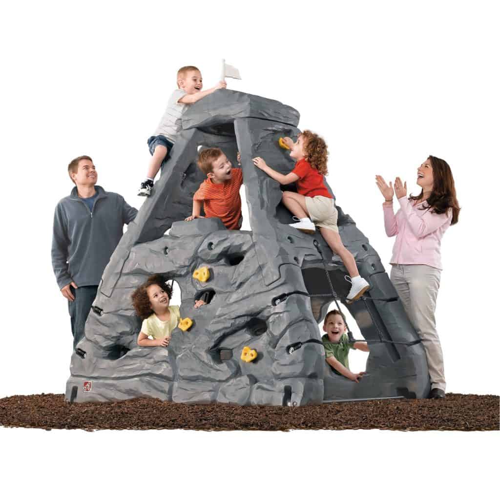 kids climbing the plastic rock play set