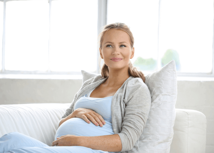 pregnant woman holding stomach