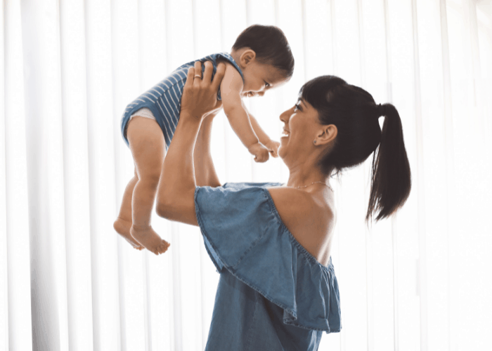 mom holding baby up