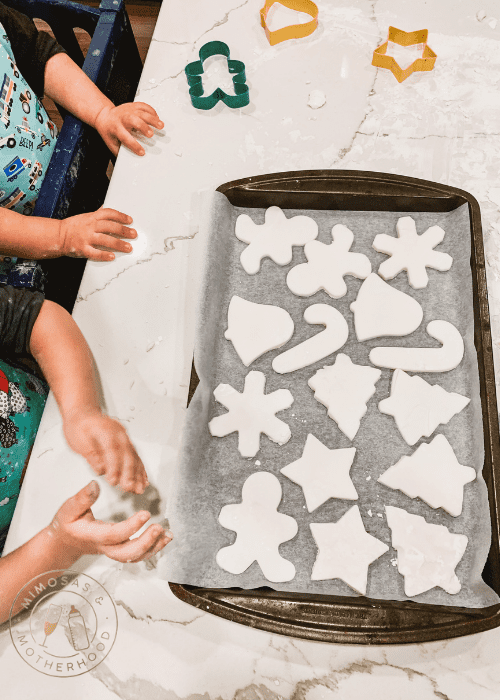 image shows hands by a tray of air dry clay ornaments