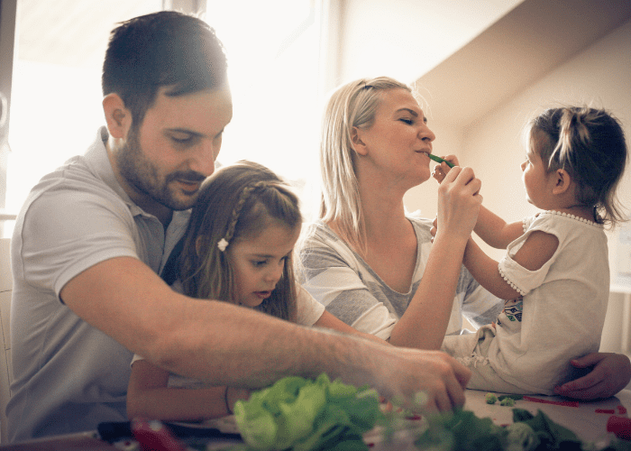 image shows a family in the kitchen