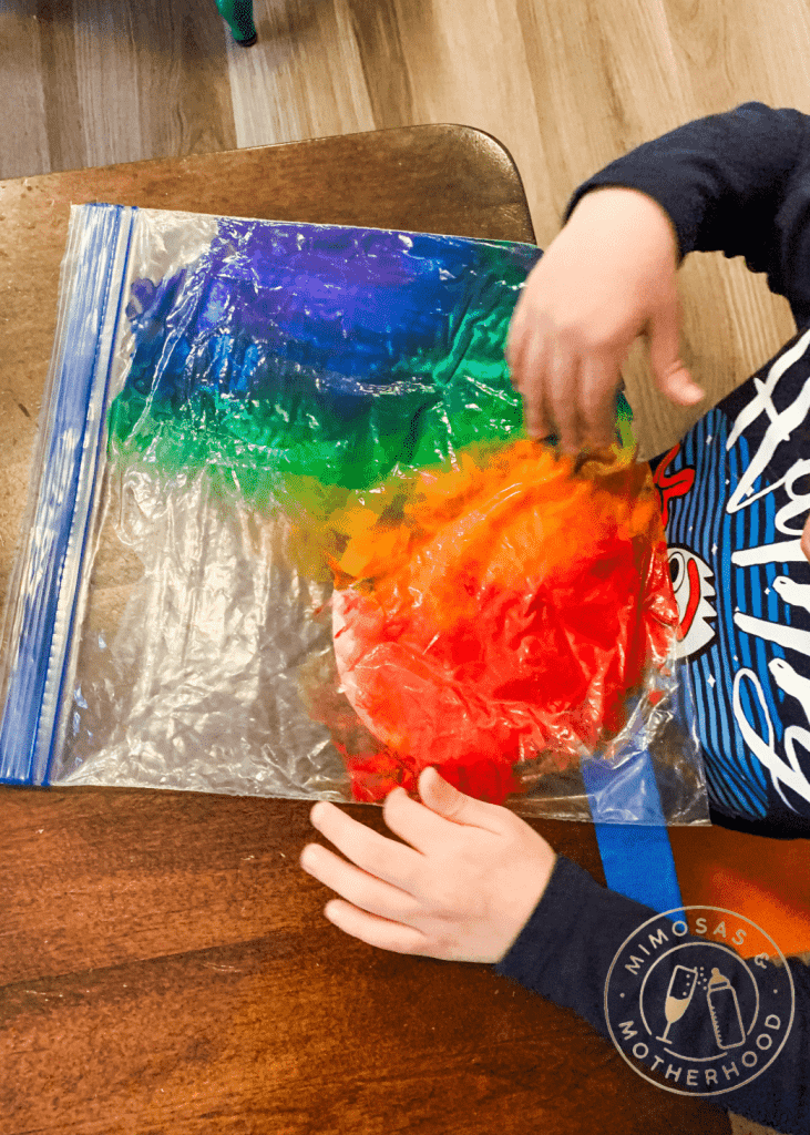 image shows a child painting in a bag