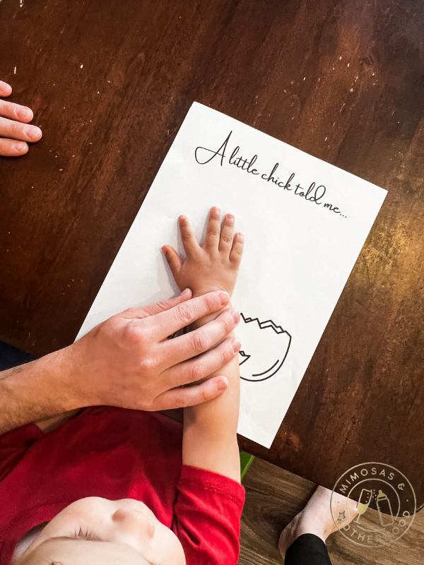 pressing child's hand to paper