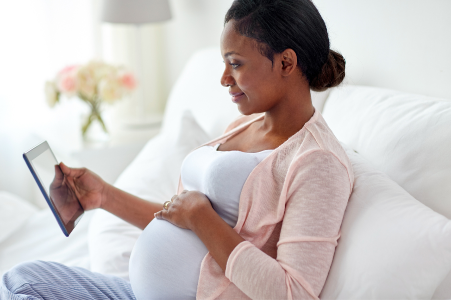 pregnant woman looking at tablet