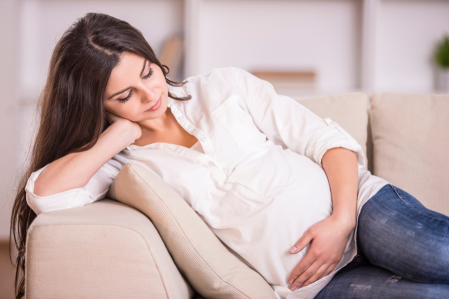 pregnant woman holding stomach