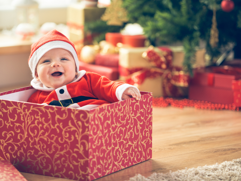 baby in a wrapped Christmas gift box