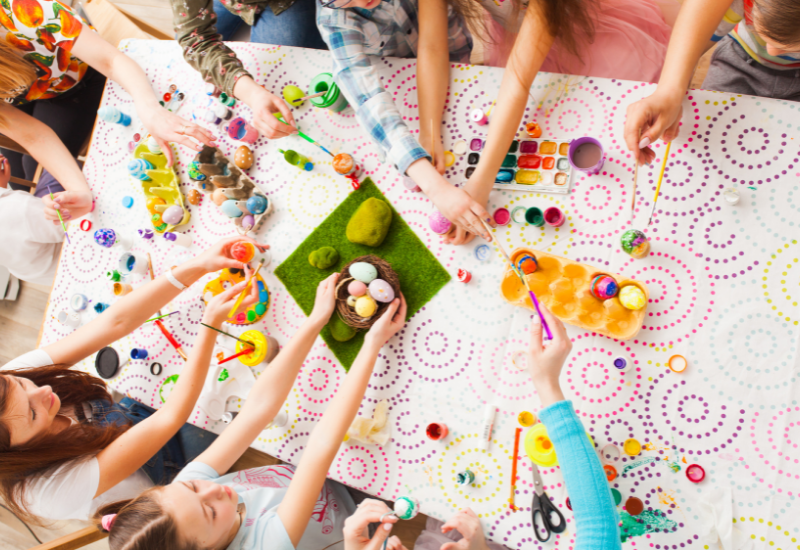 kids doing easter crafts at table