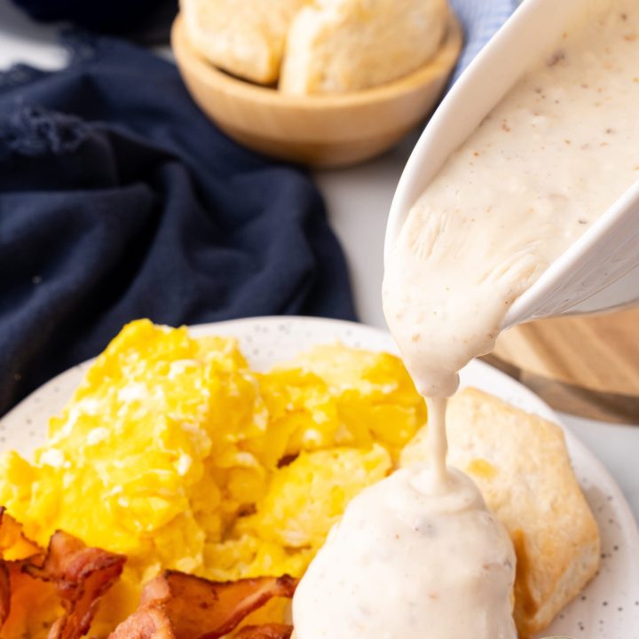 white southern gravy being poured on breakfast foods