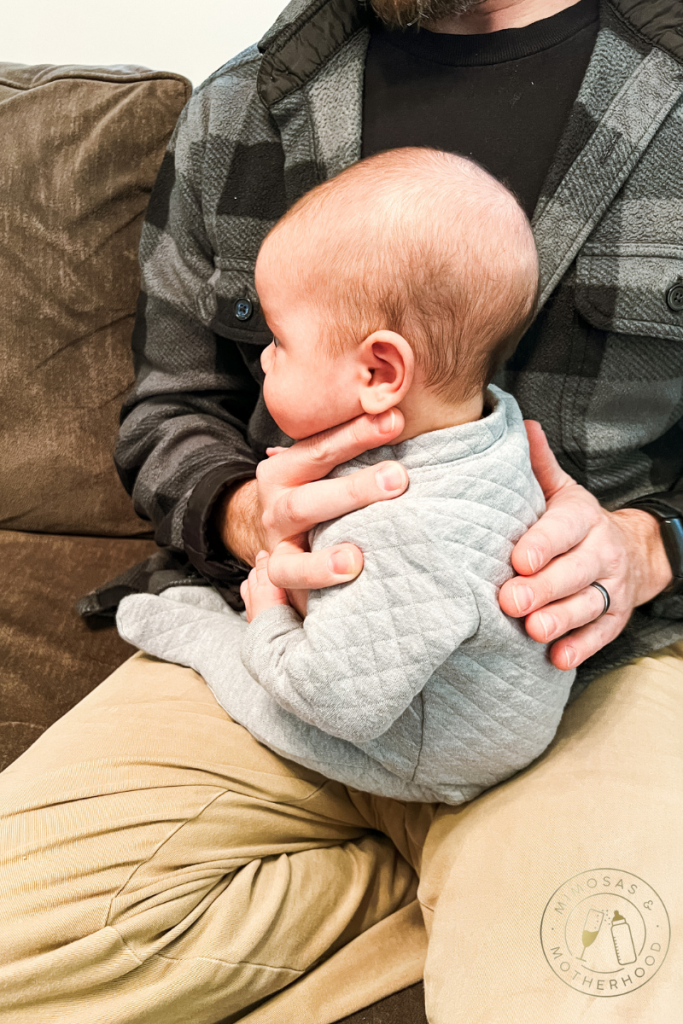 burping baby sitting on lap