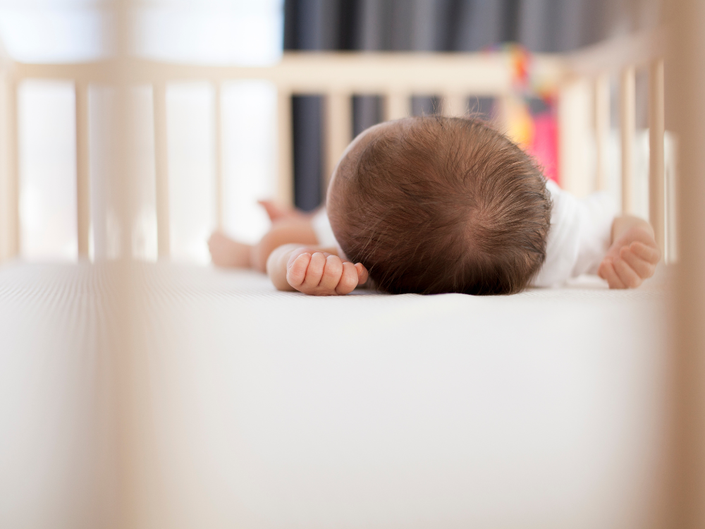 newborn baby sleeping in crib