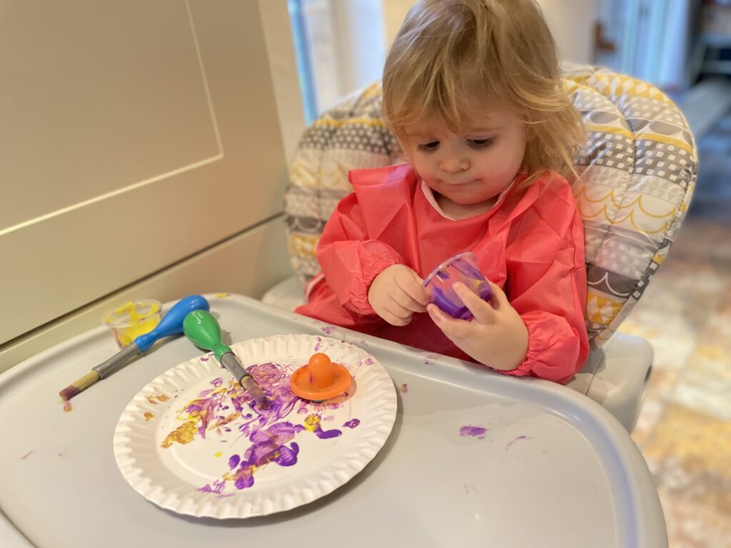 Image shows a child finger painting