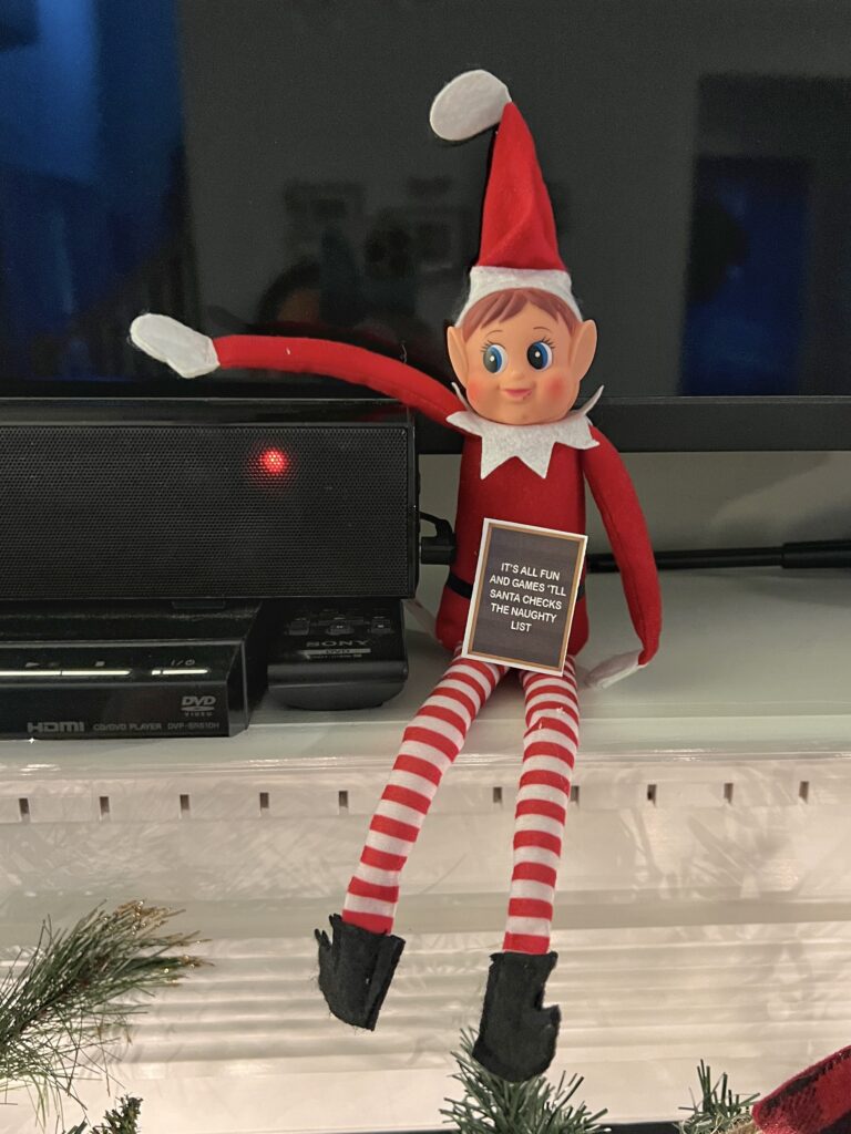 elf sitting on shelf with printable letter board prop