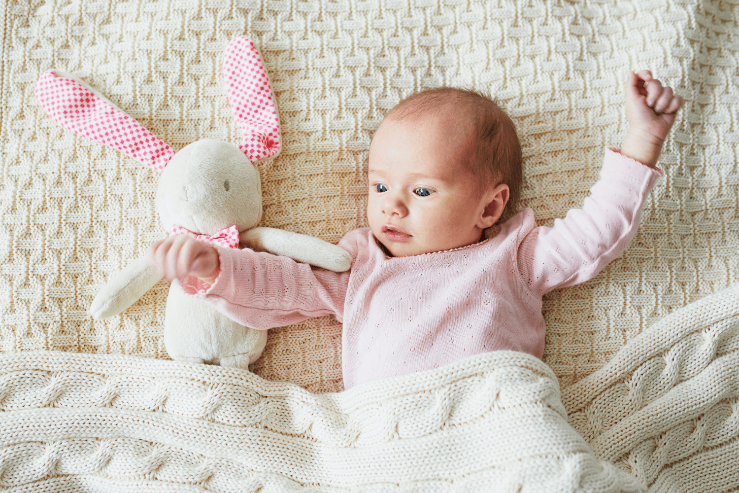 newborn baby with bunny stuffed animal