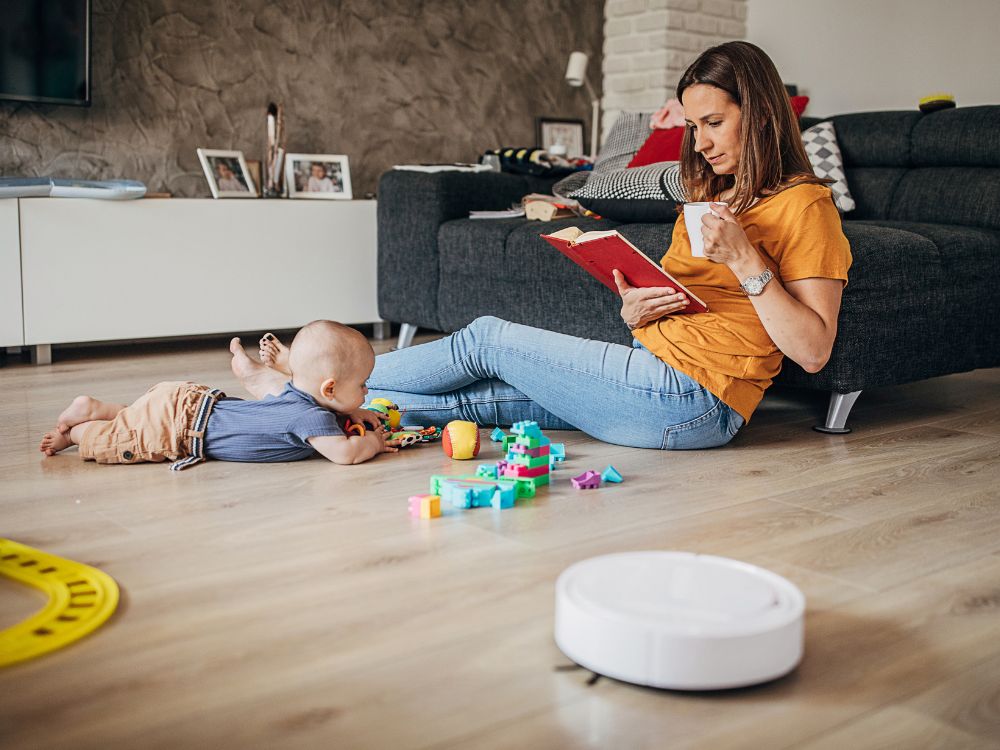 Mother and baby with robot vacuum