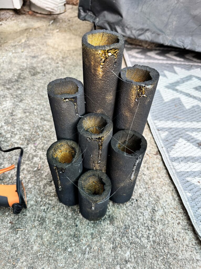 image shows black halloween candles with fake melted wax made from hot glue
