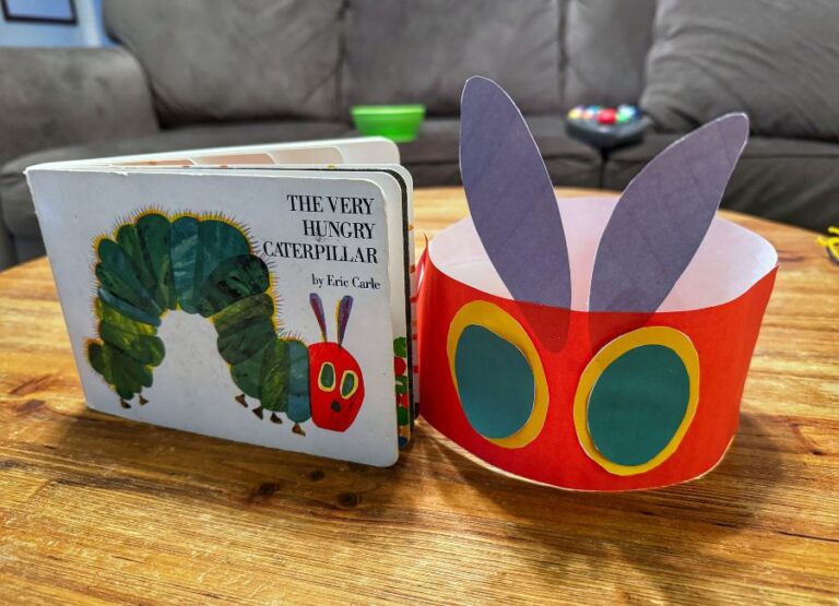 image shows paper caterpillar crown with book