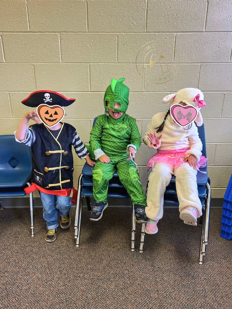 image shows kids sitting during Halloween party