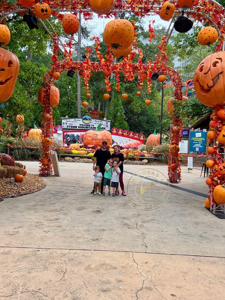 image shows a family at a Halloween pumpkin festival