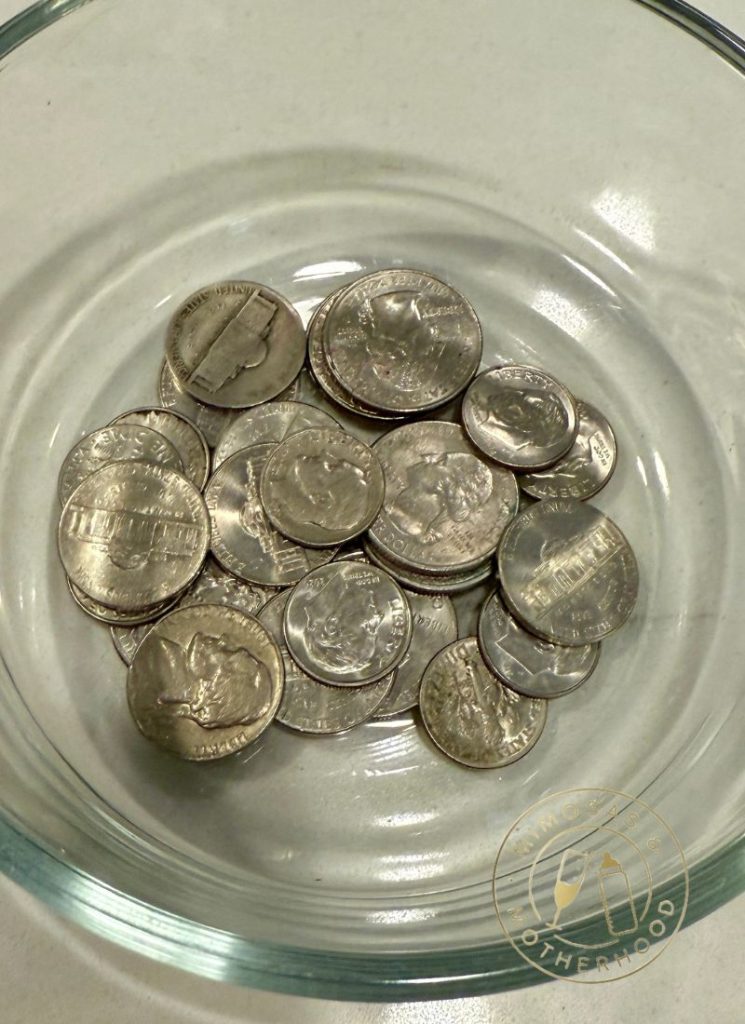 nickel coins in a glass dish