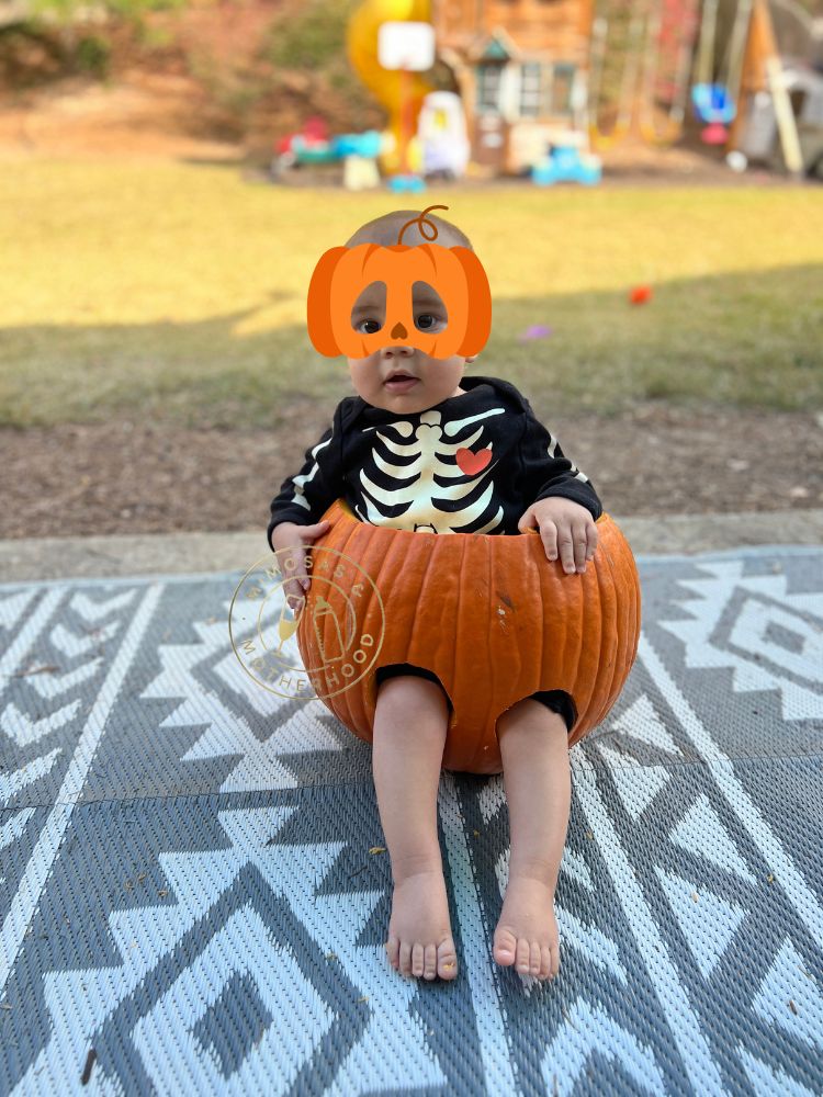 image shows a baby in a pumpkin