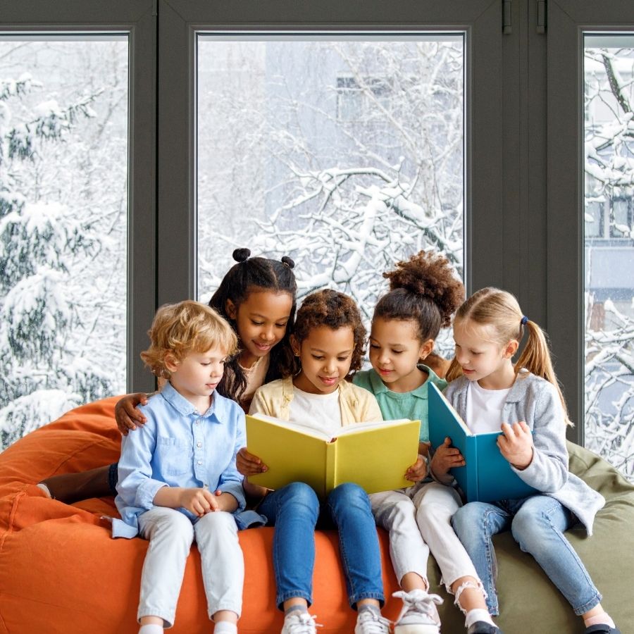 image shows children reading in front of a winter window
