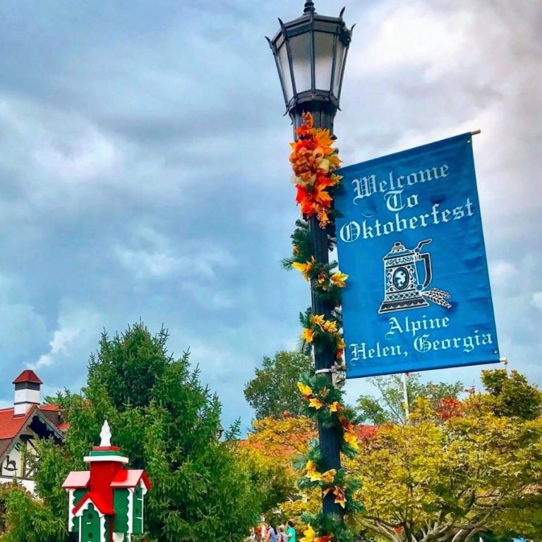 image shows a light post with an oktoberfest banner on it