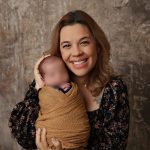 woman holding baby during newborn photoshoot