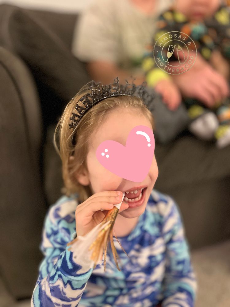 image shows a child celebraring new year's eve