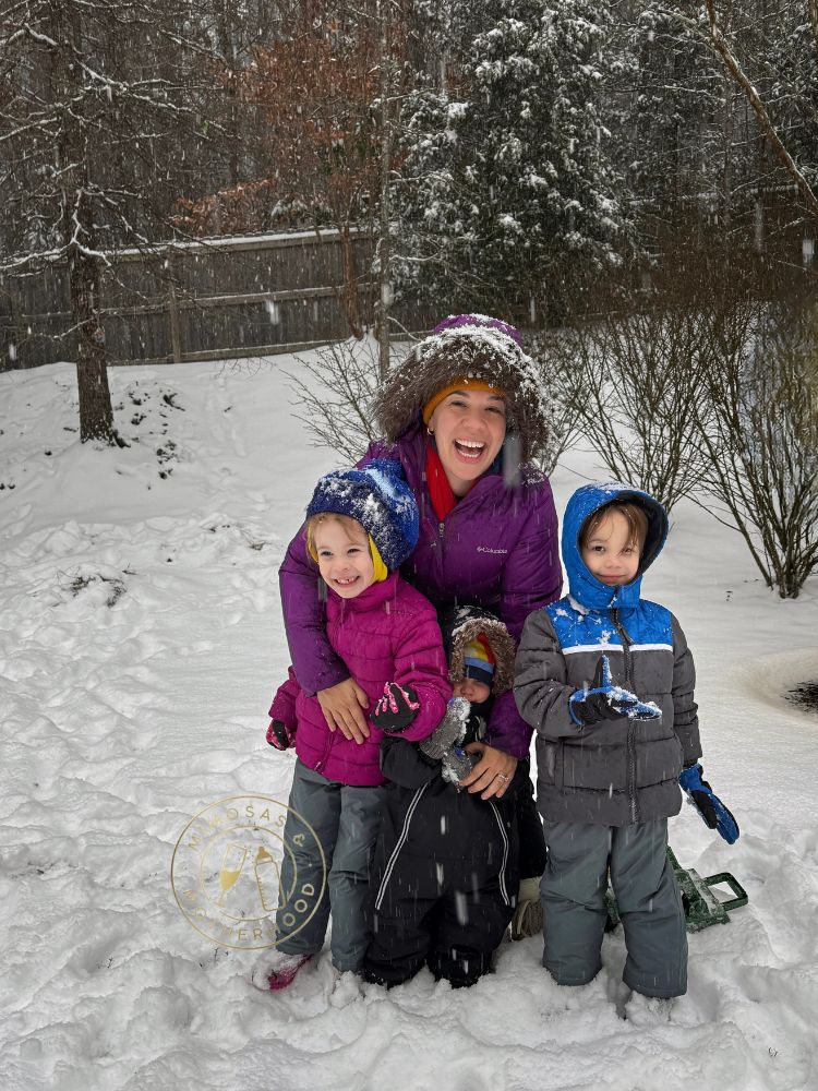 image shows a family outside in the snow