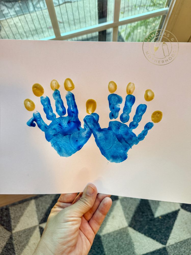 image show Hanukkah handprint art in the shape of a menorah