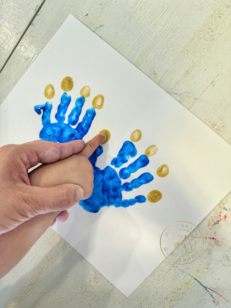 image shows a finger creating the flames of the candle art