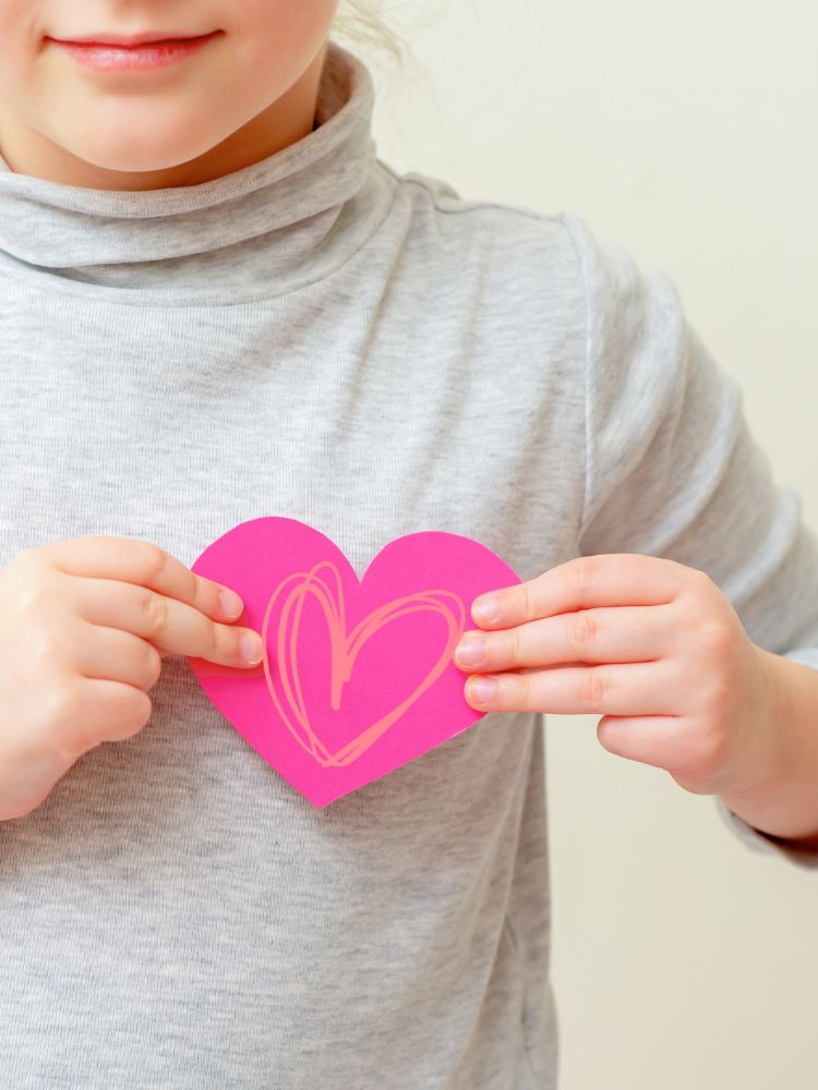 child holding a valentines day heart