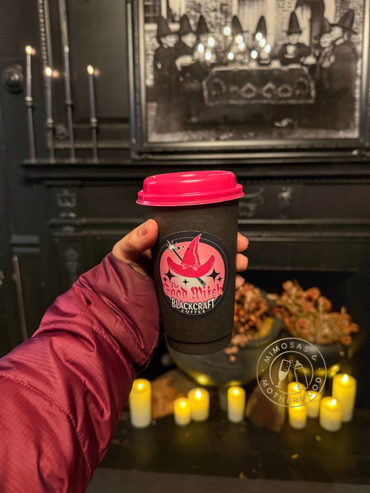 Hand holding The Good Witch red velvet coffee at Blackcraft Coffee