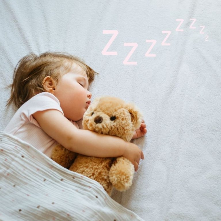 image shows a toddler sleeping with a teddy bear