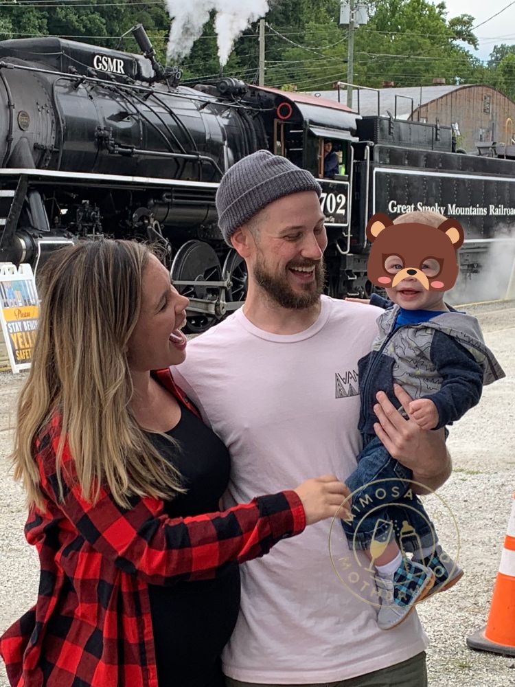 Family with child in front of train in Bryson City