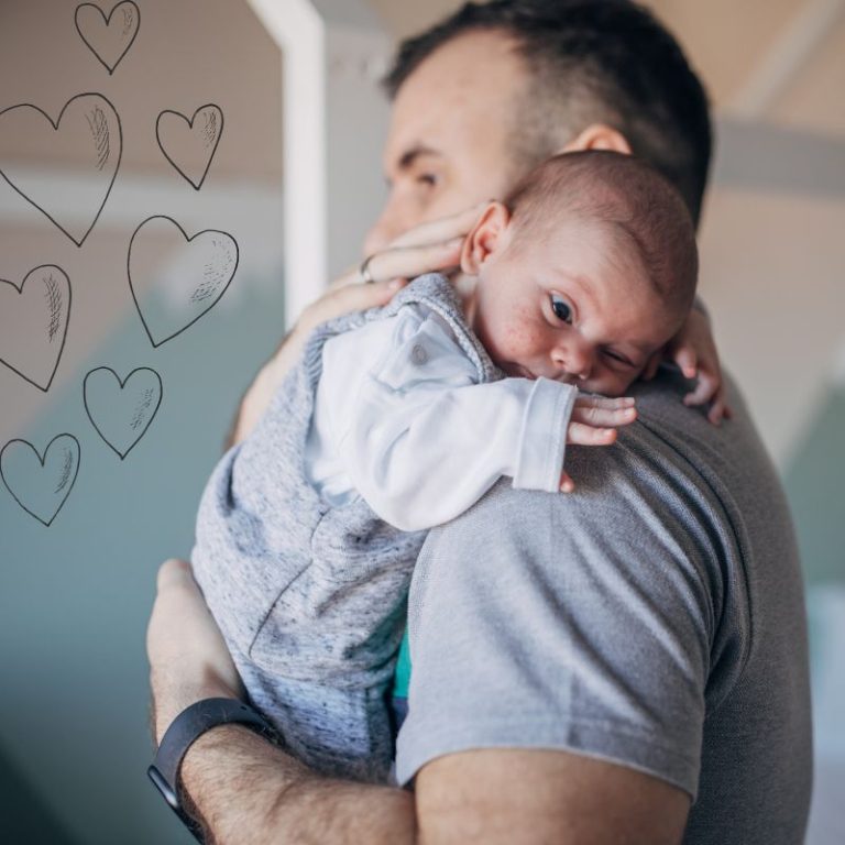image shows a man holding a baby