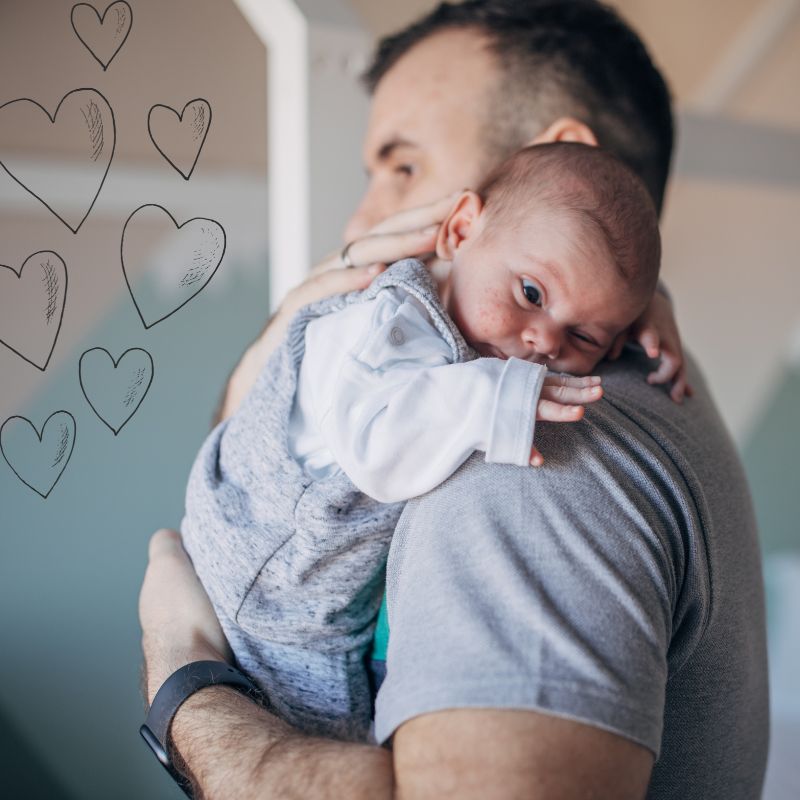 image shows a man holding a baby