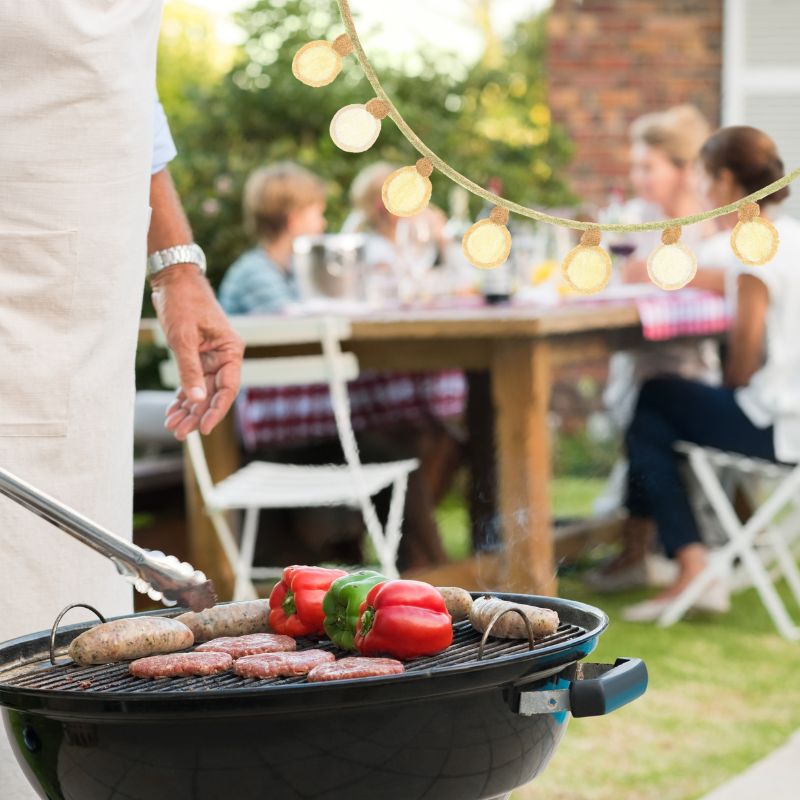 image shows a family outside with a bbq