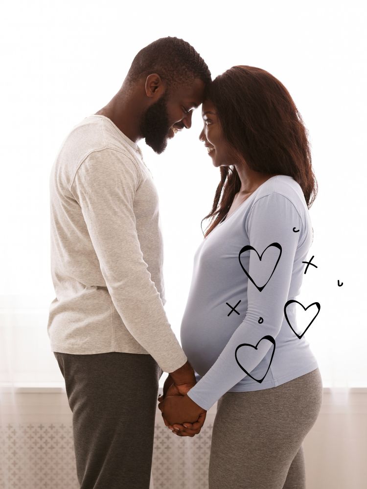 image shows an expecting couple holding hands