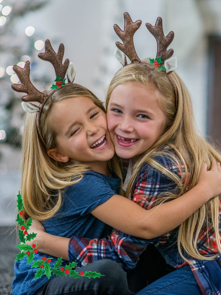 image shows children hugging with Christmas headbands on