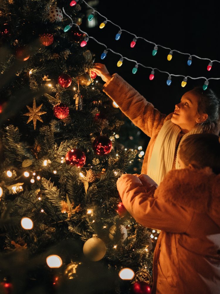 image shows children decorating the Christmas tree
