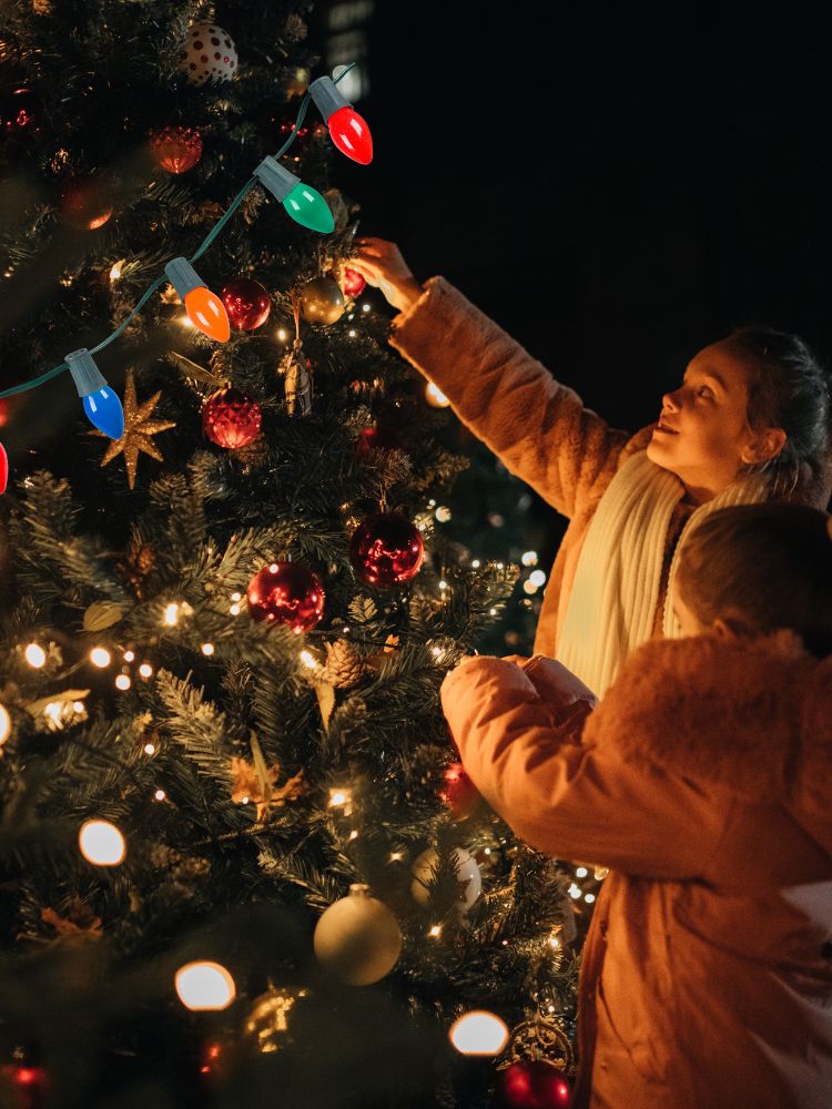 family decorating a christmas tree